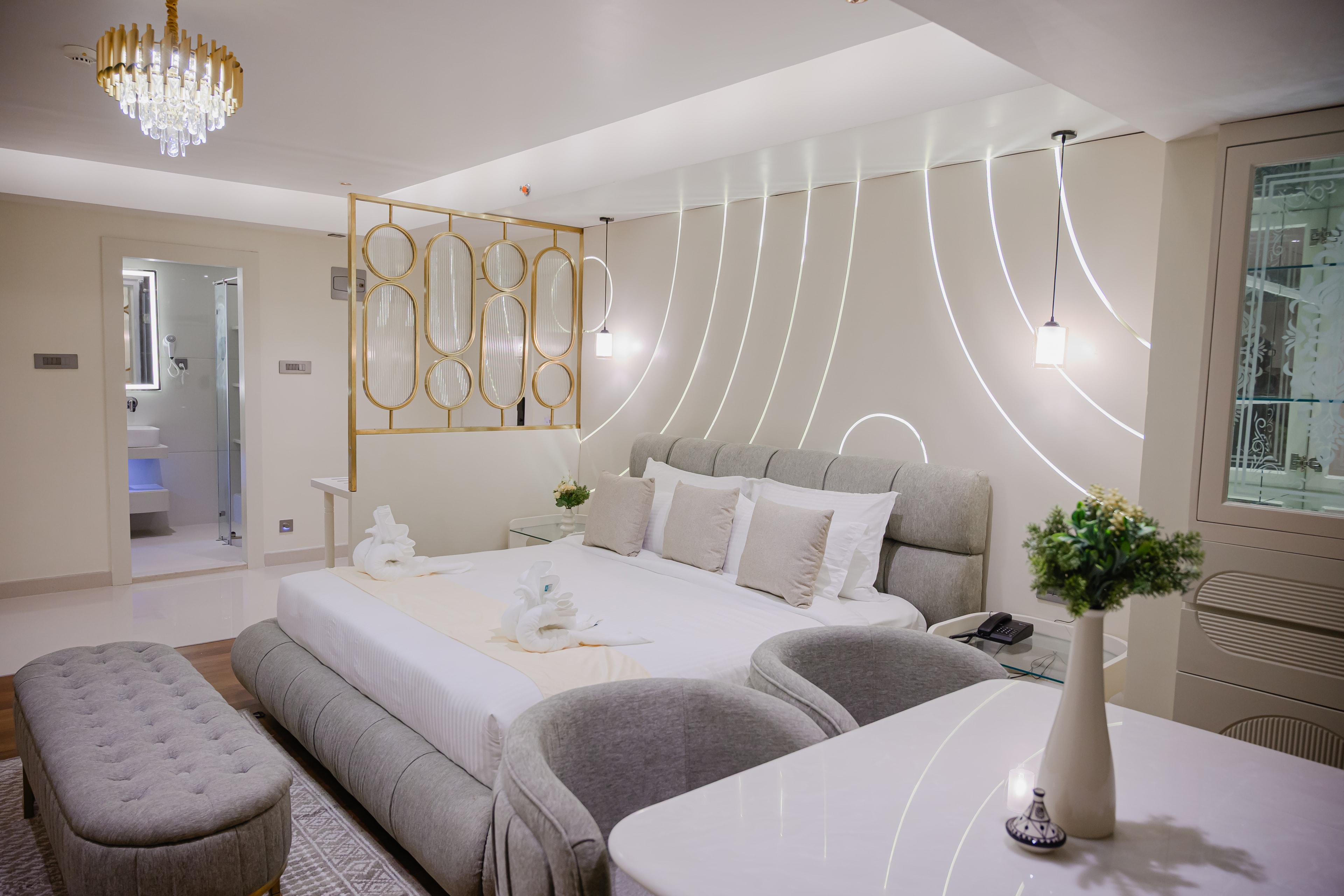 Presidential Suite - Elegant bedroom with sophisticated gold accents and premium furnishings